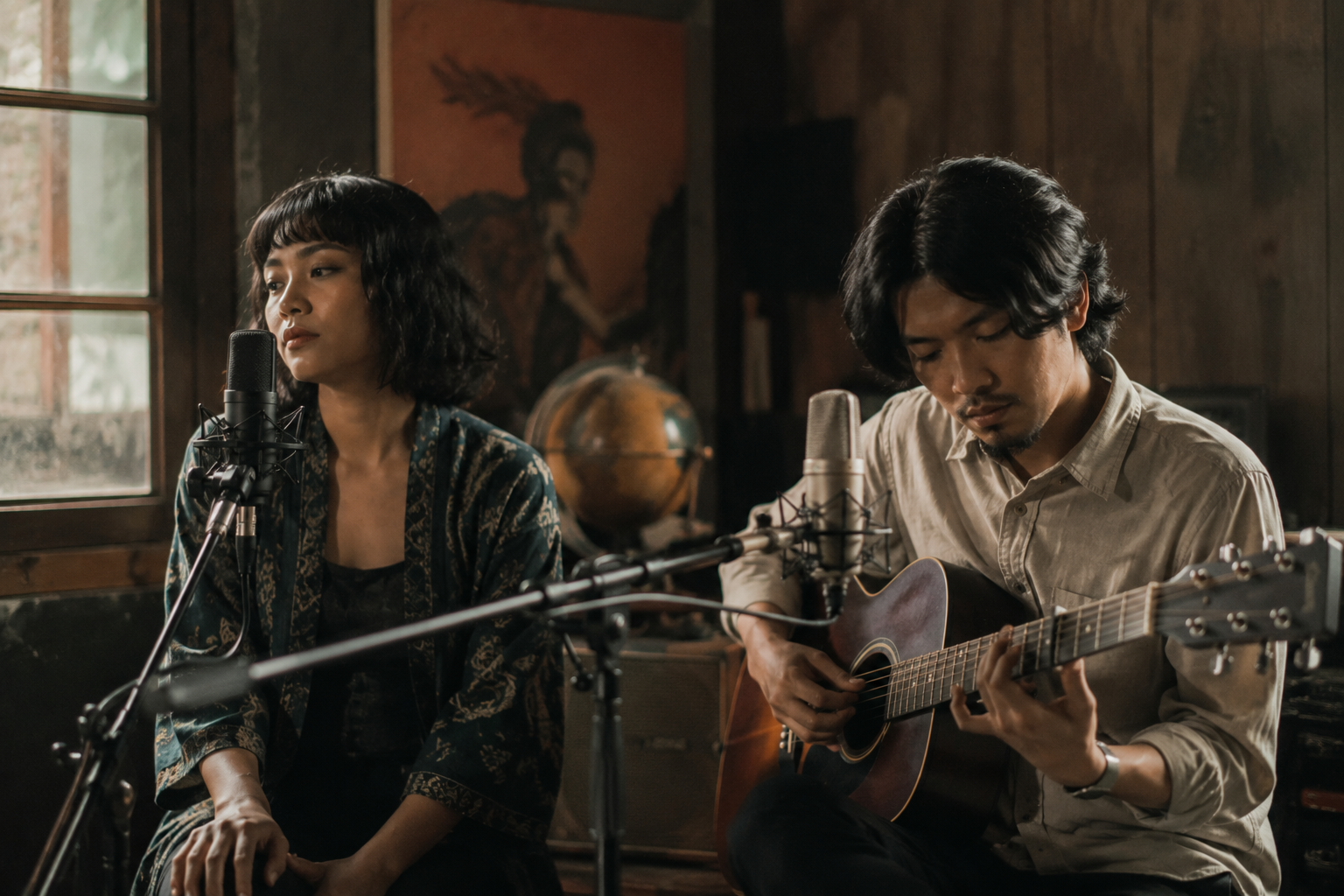 Banda Neira tampil membawakan lagu folk di atas panggung dengan gitar akustik dan pencahayaan hangat