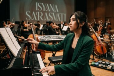 Isyana Sarasvati tampil memainkan piano saat konser musik dengan karakter musikal yang khas.