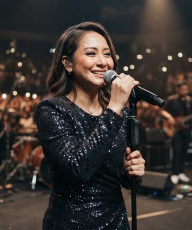 Bunga Citra Lestari tampil membawakan lagu di atas panggung konser dengan penampilan elegan dan vokal yang khas.